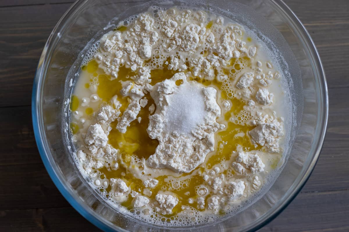 flour, water, salt and olive oil are placed in a bowl