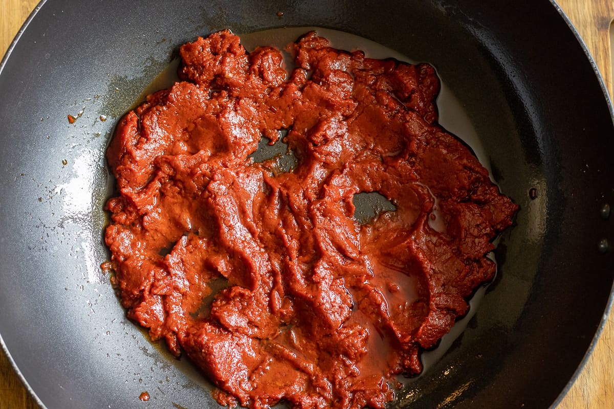 Sautéing the red pepper paste and tomato paste with olive oil