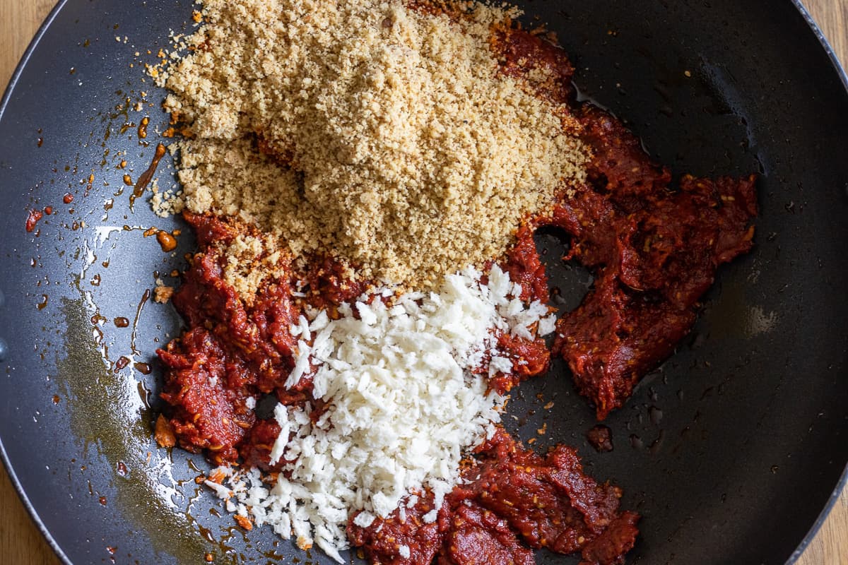 breadcrumbs and walnuts are added to tomato and pepper paste