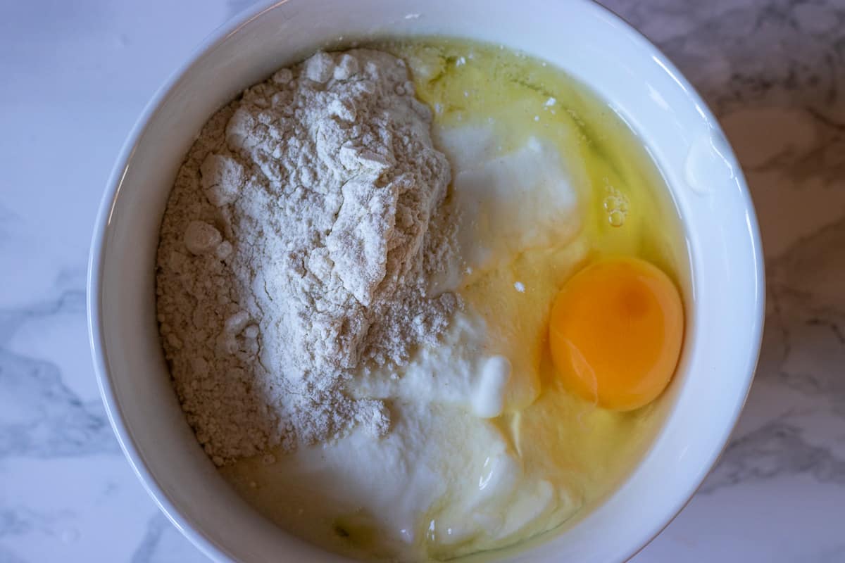 egg, yoghurt and flour are placed in a bowl