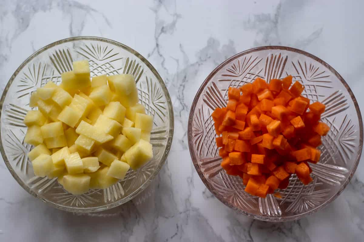 carrots and potatoes are cut into small cubes