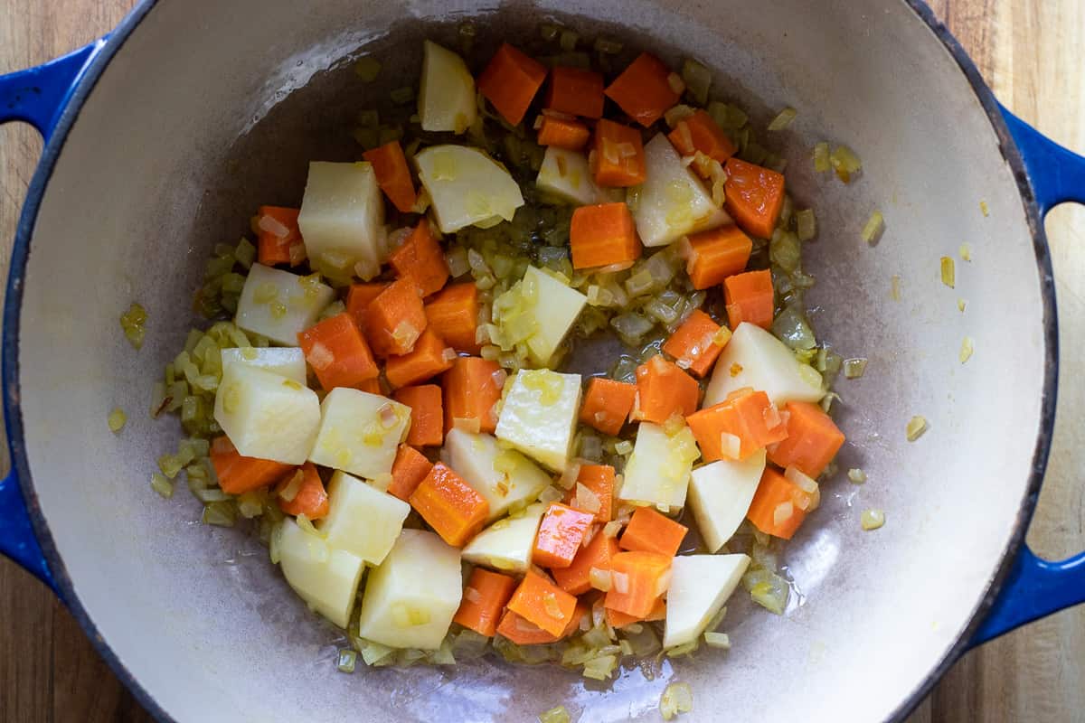 diced carrots and potatoes are added to sautéed onions