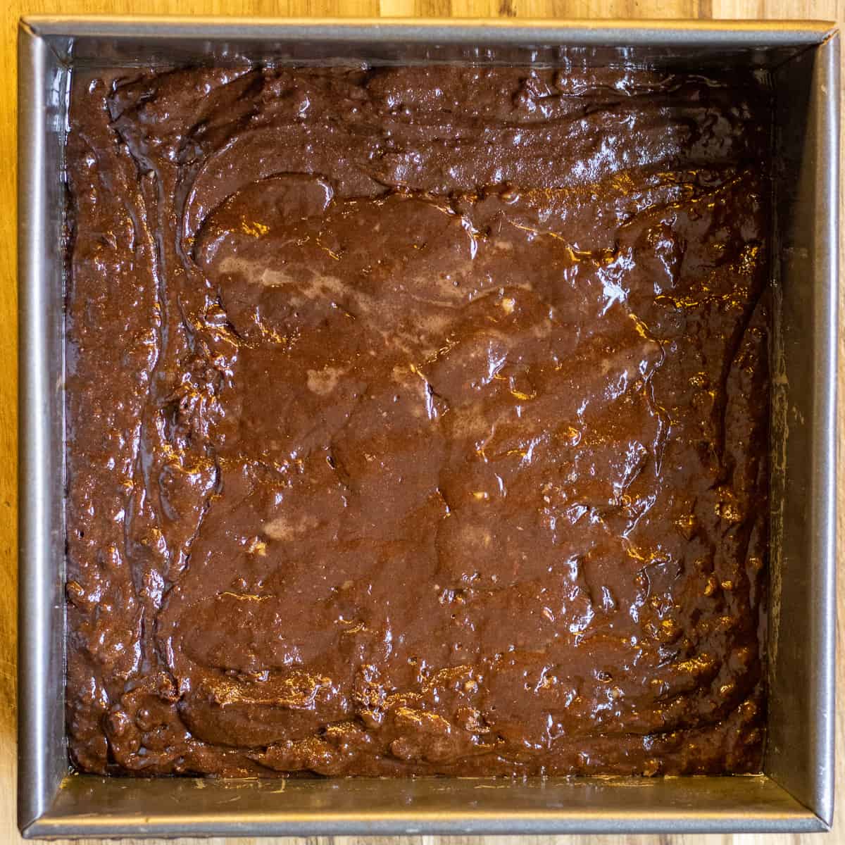 browni batter is spread in a cake pan