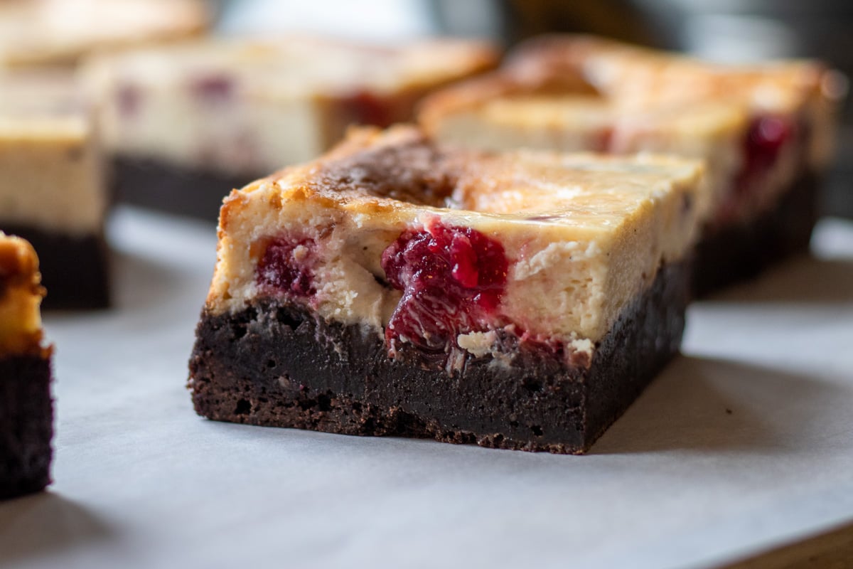 a slice of cranberry cheesecake brownies