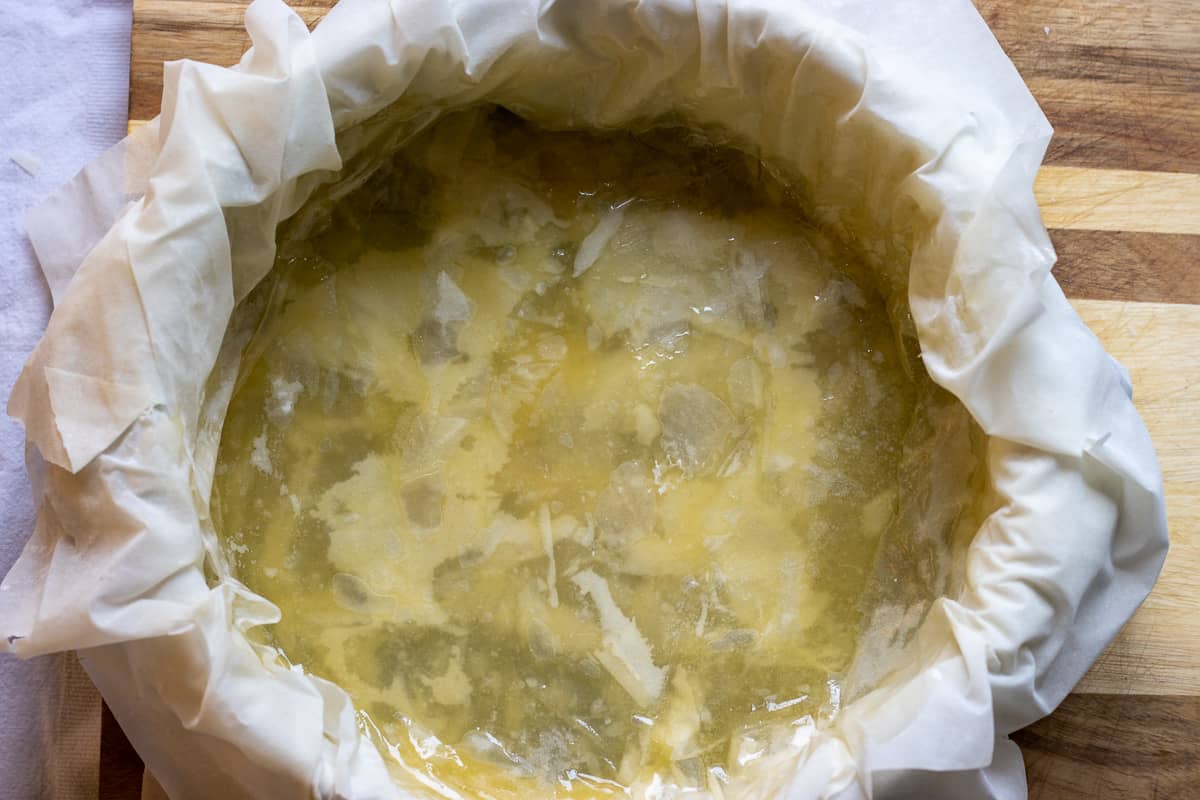 layering the filo sheets on cake pan