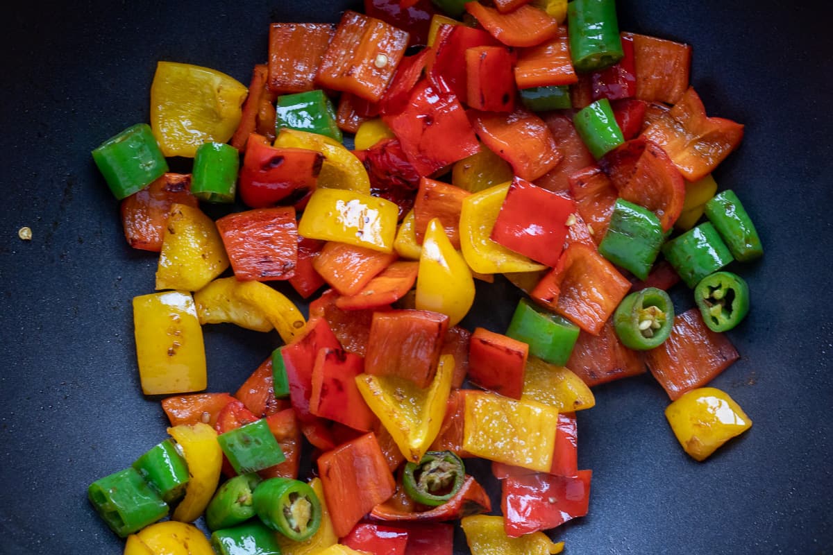 Sautéing the peppers in a wok
