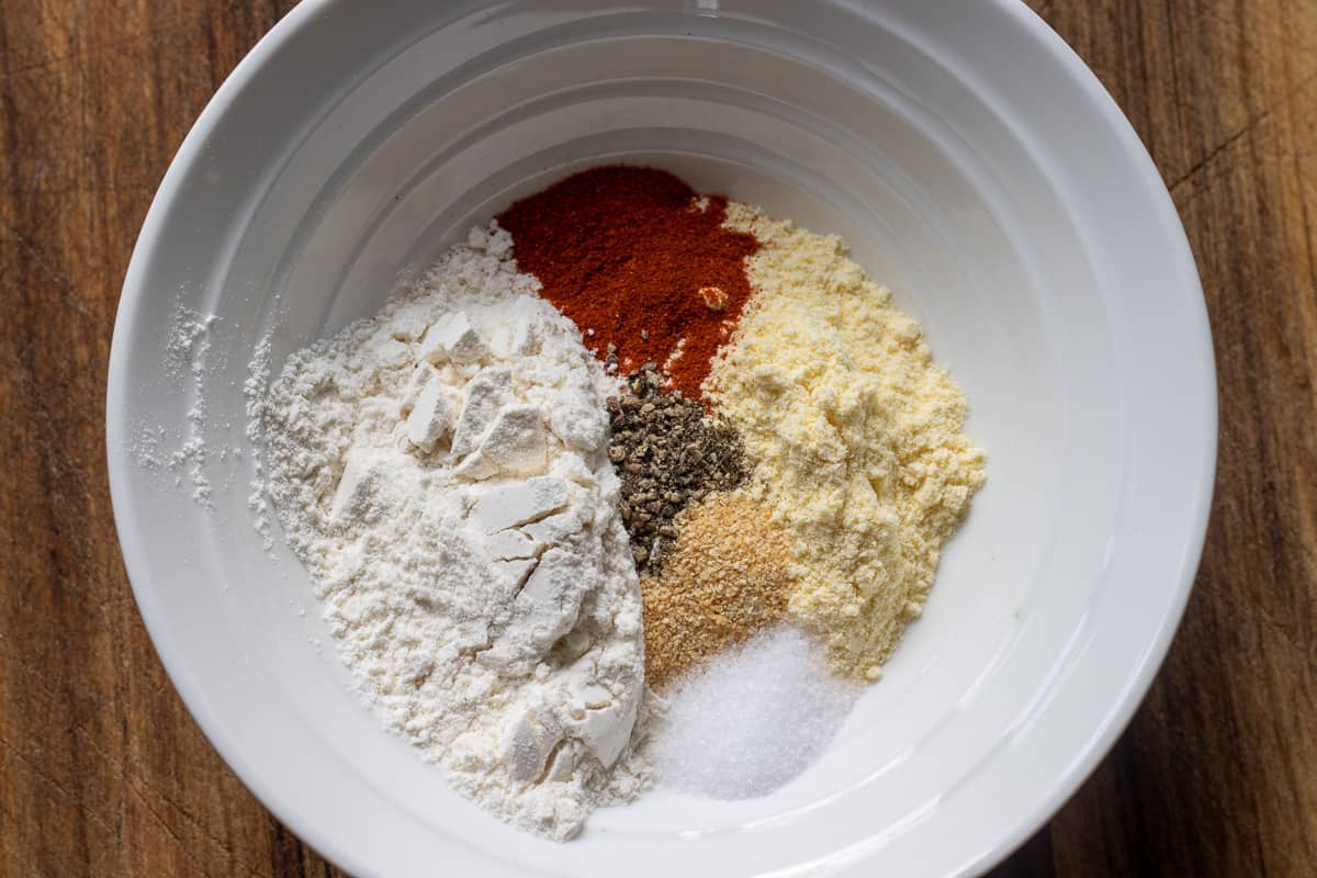 flour, cornmeal and spices are placed in a bowl