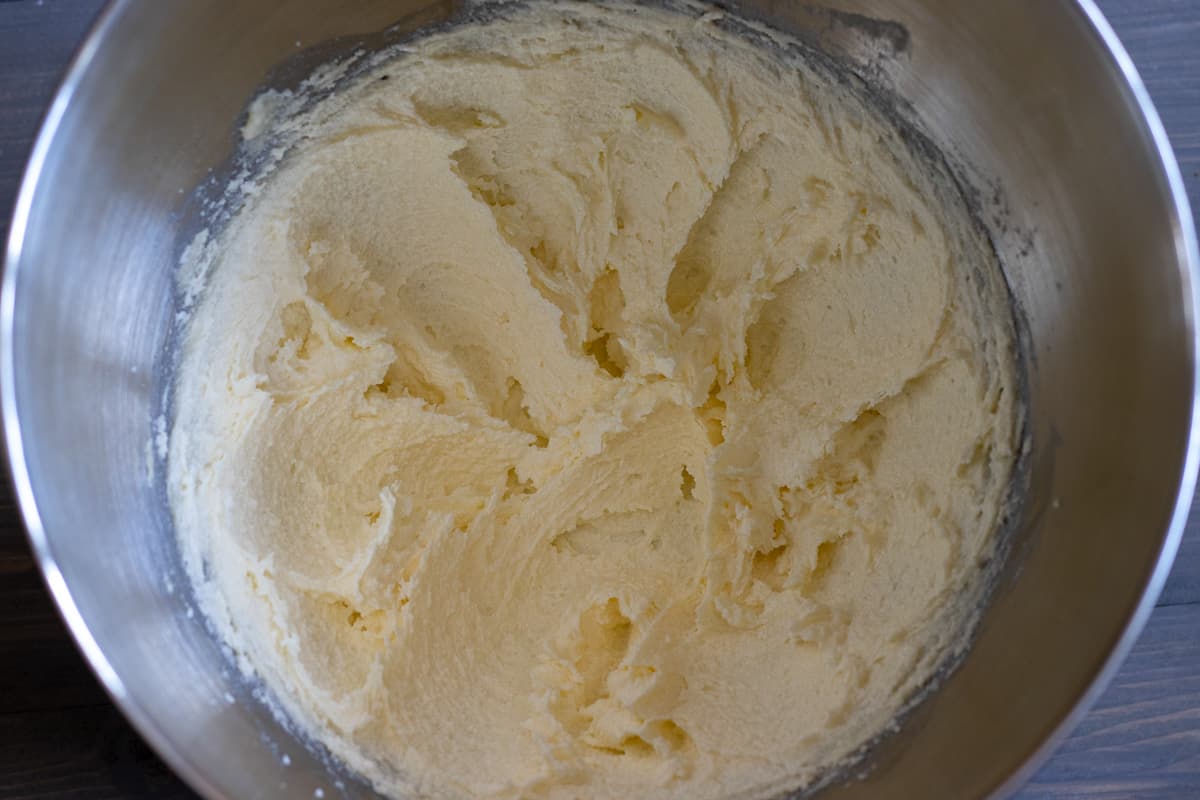 softened butter is mixed with sugar until fluffy