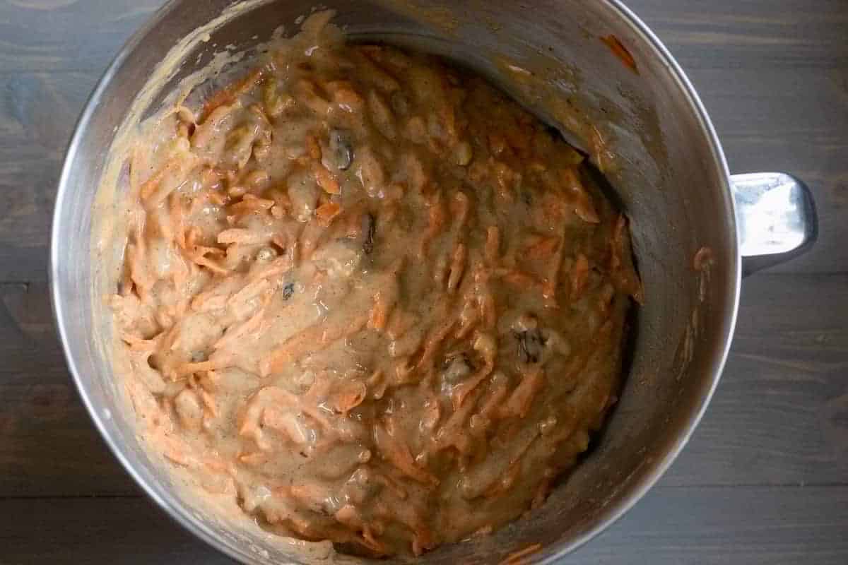 grated carrots, walnuts and raisins are added to the cake mixture