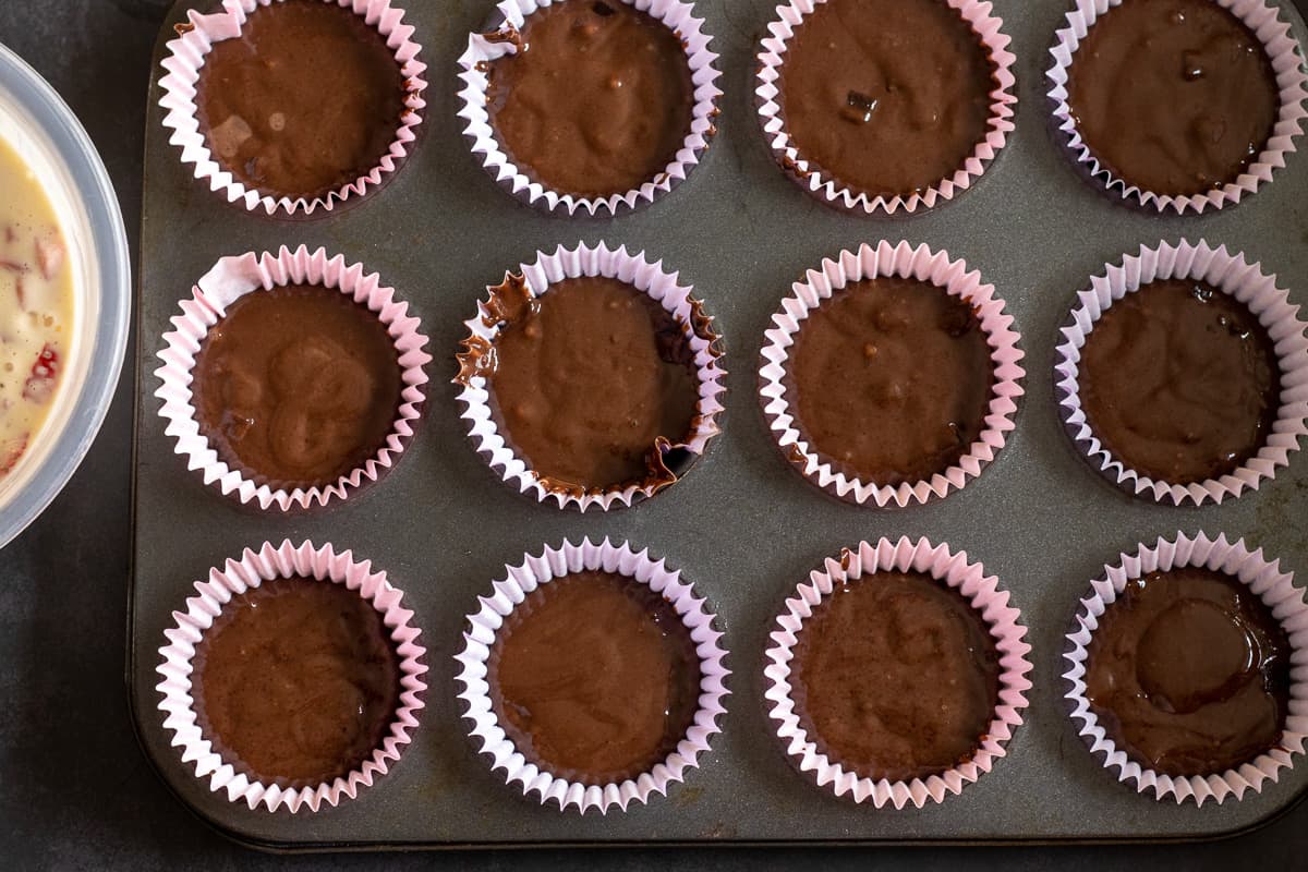 chocolate muffin batter is placed in muffin tin
