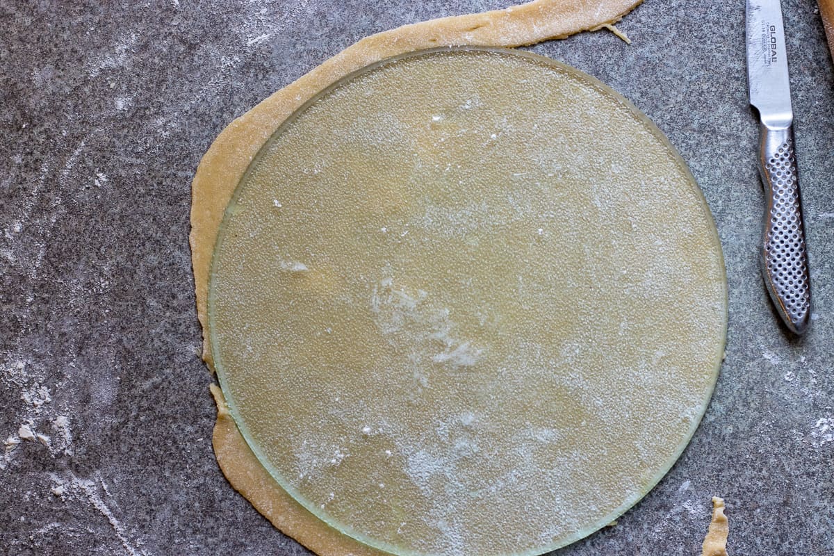 rolling the dough into a 9" circle