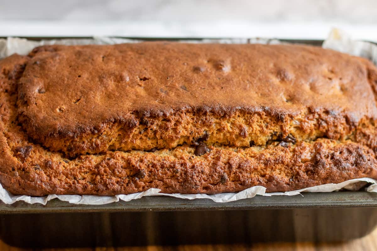 Banana bread with chocolate chips is  cooling down before slicing