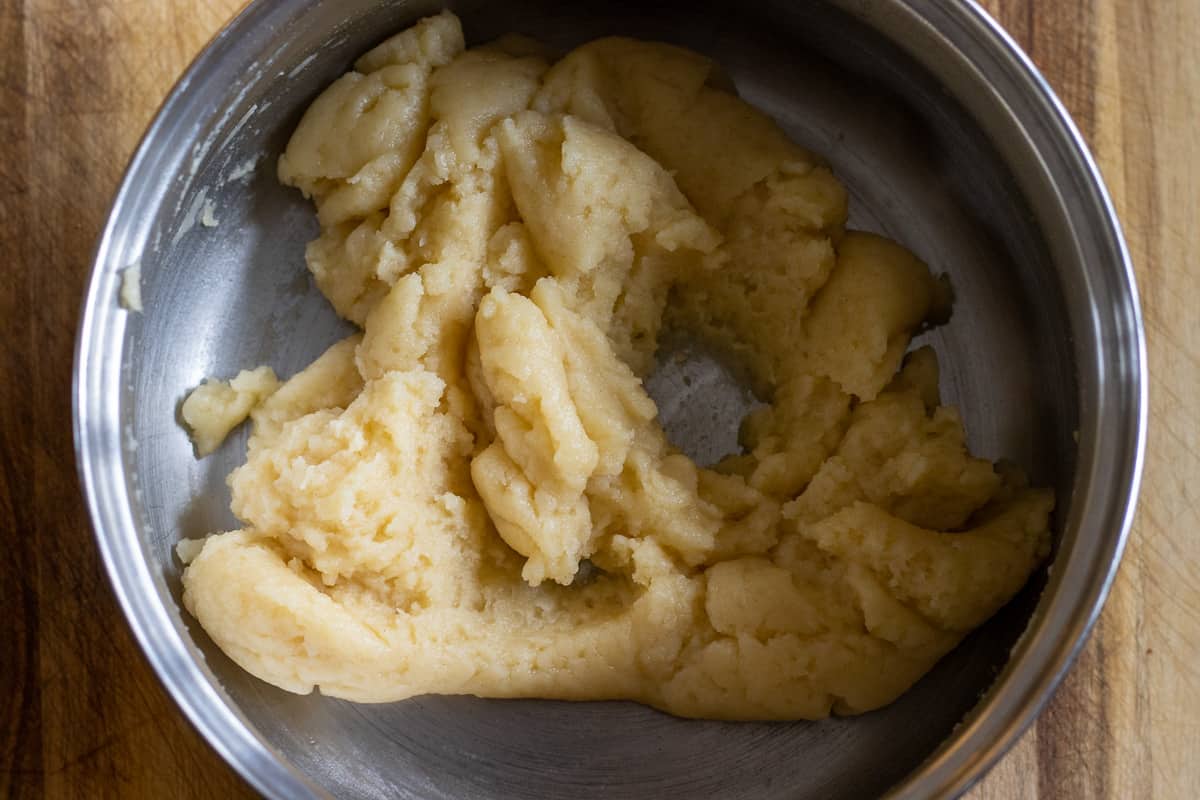 water, flour and butter are mixed to form a dough for making choux pastry