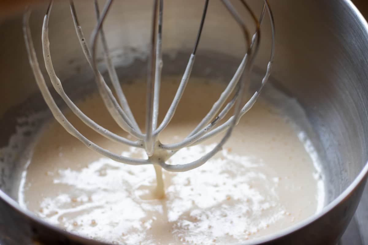 The eggs and sugar are beaten in a bowl of a stand mixer