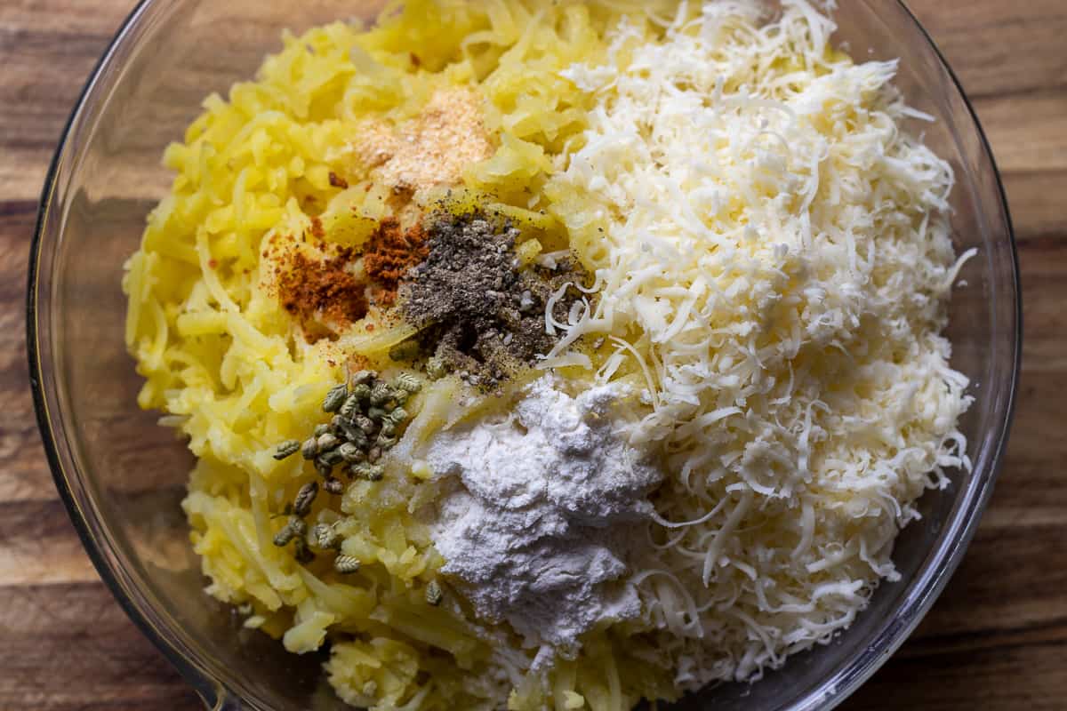 flour, cheddar and seasoning are added to grated potatoes