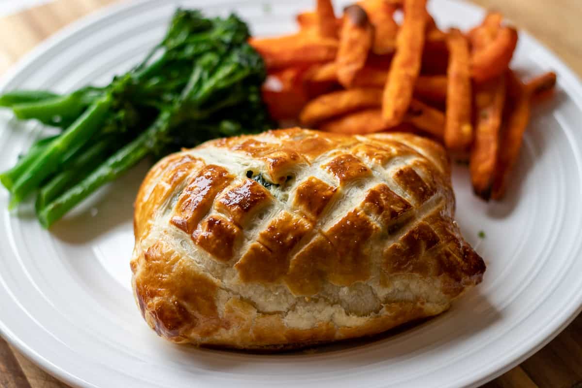 salmon en croute served with sweet potato fries and steamed greens