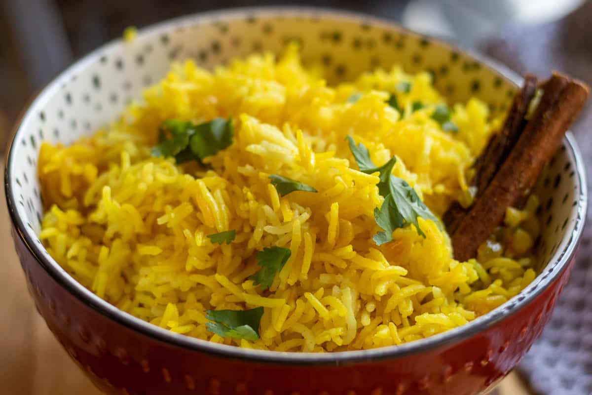 turmeric rice served in a bowl and garnished with coriander