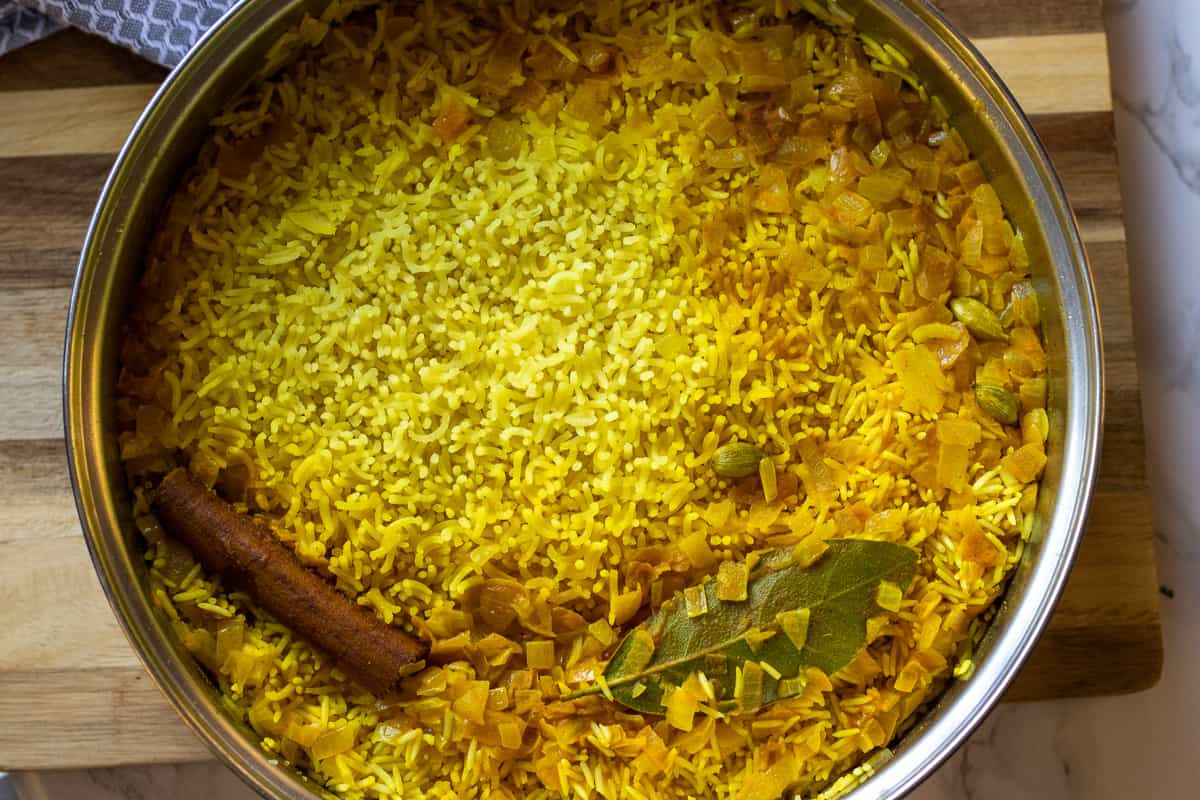 yellow rice is cooked until it absorbed all the liquid