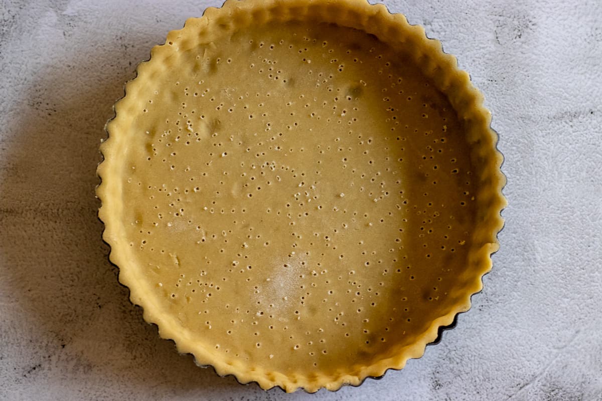 lining the tart tin with the pastry