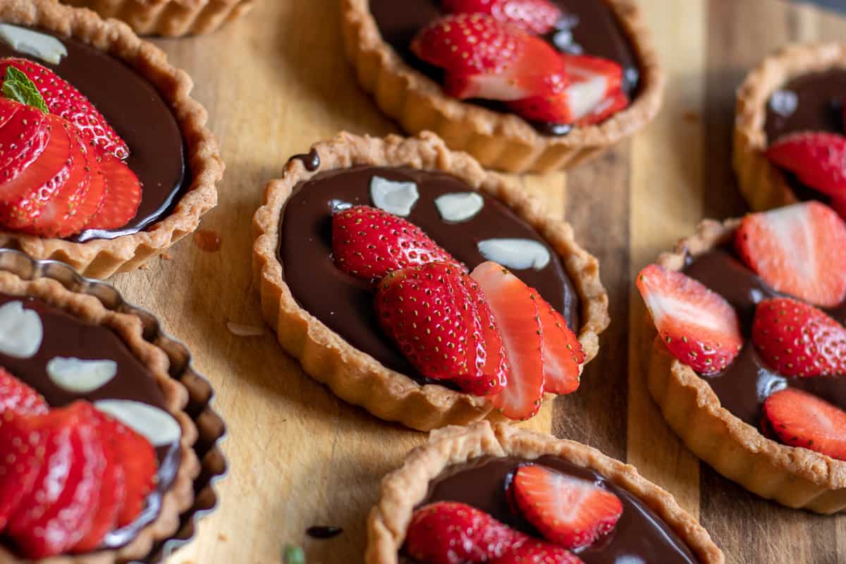 Chocolate strawberry tartlets served with fresh sliced strawberries 