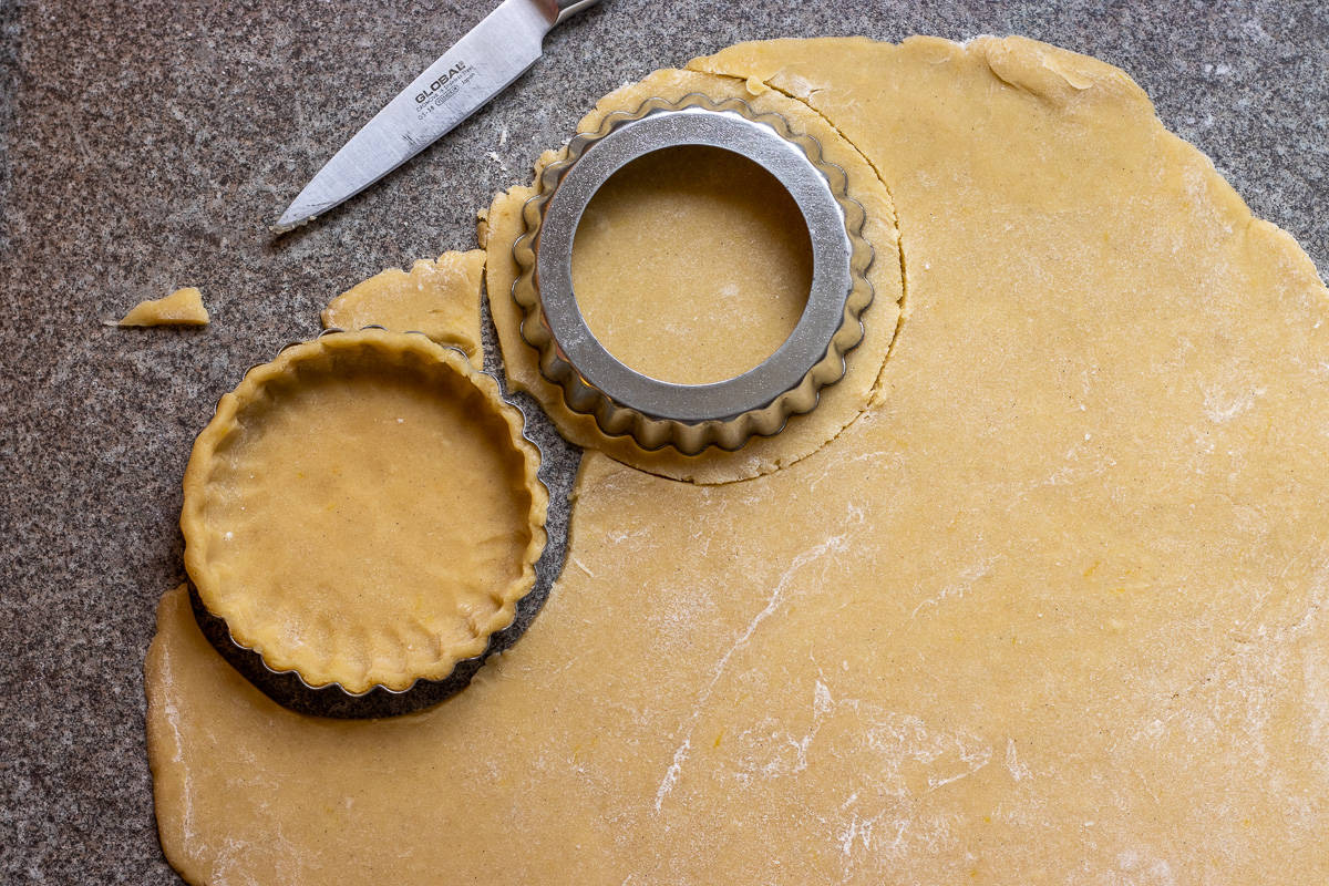 the rolled dough is cut into 10 small circles