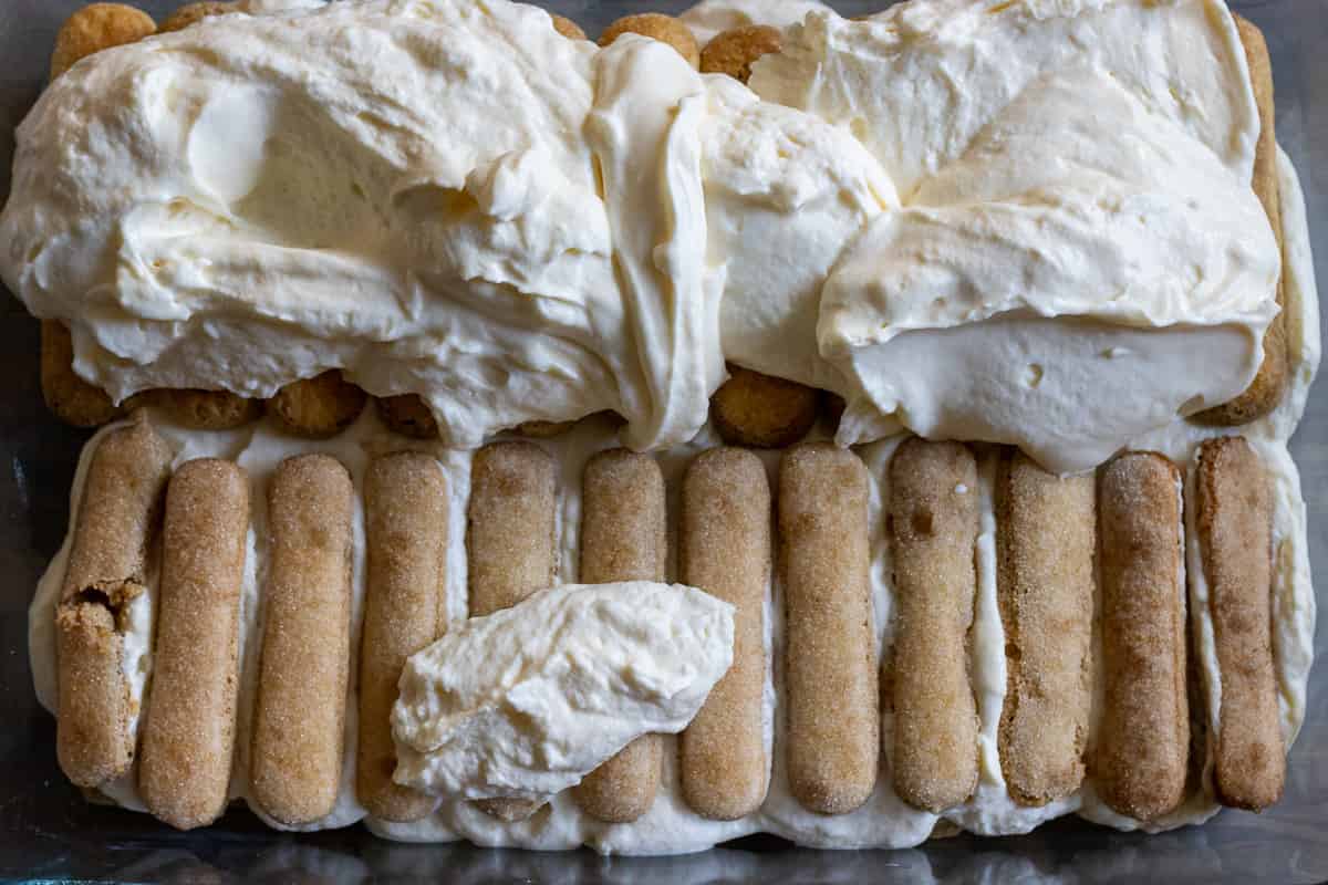 the rest of the mascarpone filling is spread over the ladyfinger biscuits 