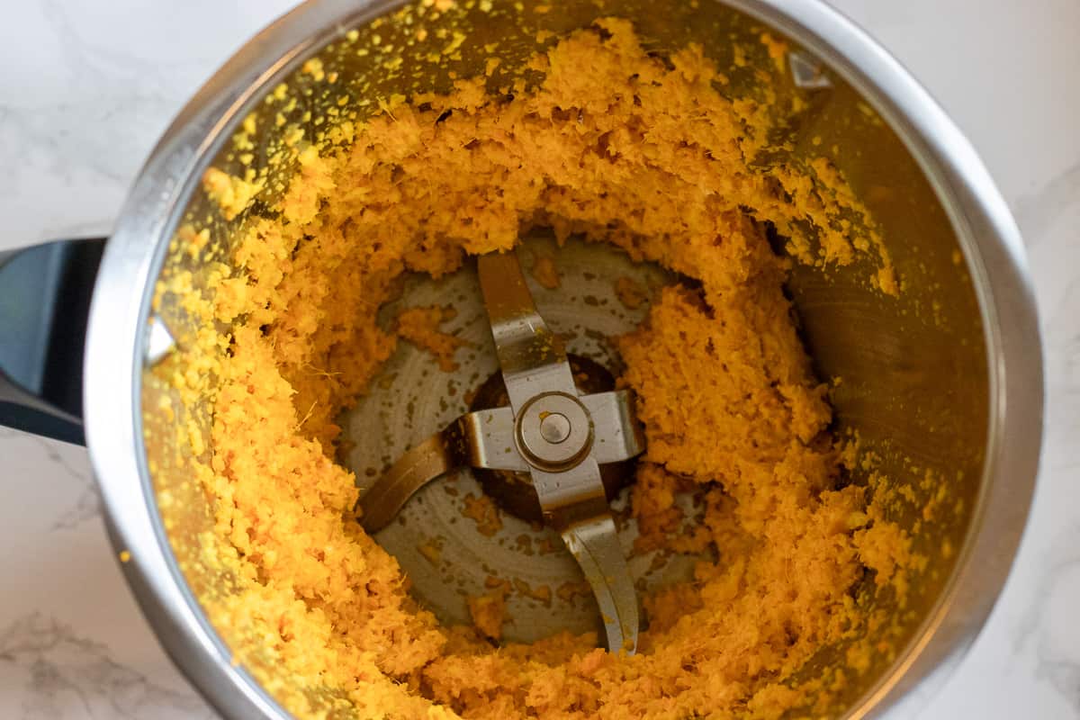 ginger, garlic, and turmeric are turned into a smooth paste using a food processor 