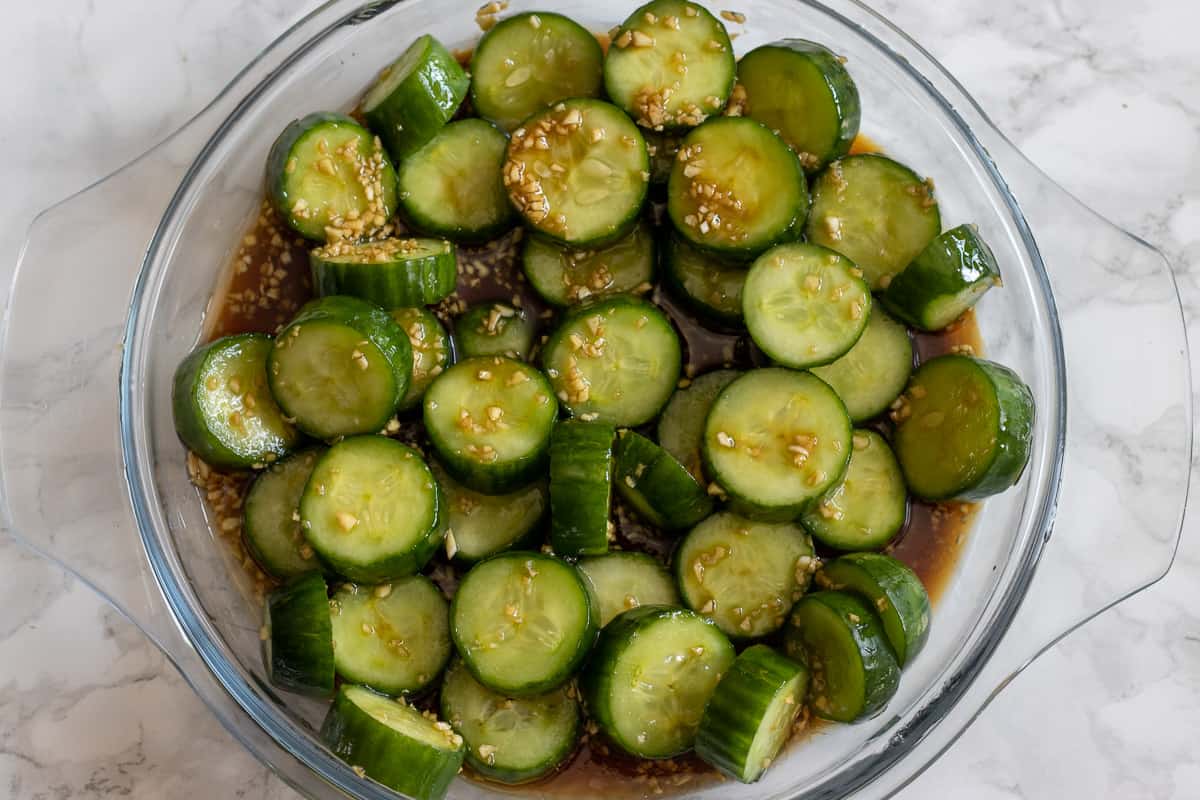 the marinade is poured over the sliced cucumbers