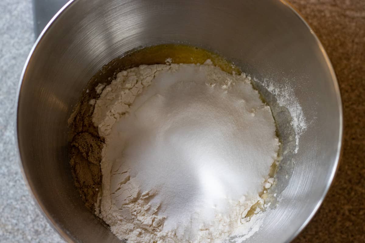 the sugar and flour is added to the bowl to form a dough