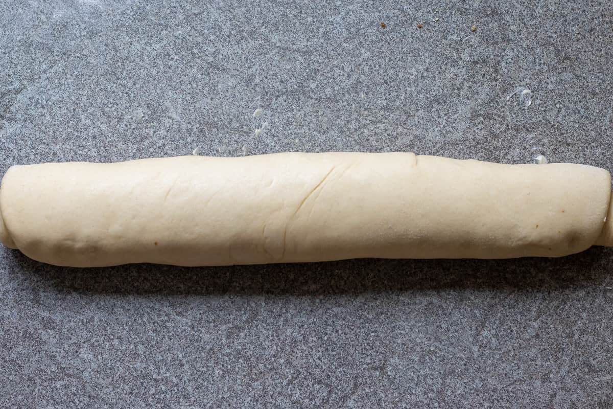 the dough is rolled tightly into a log