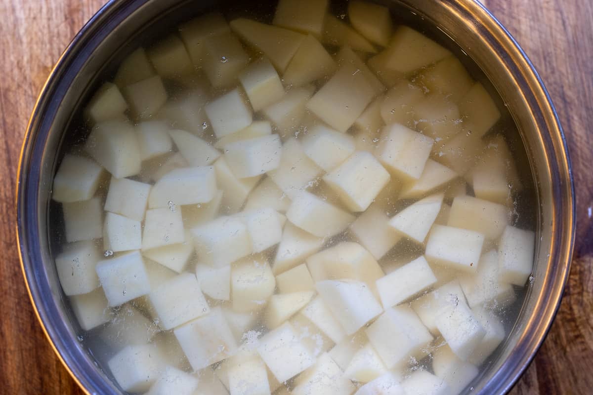 Diced potatoes are in a pan with full of water