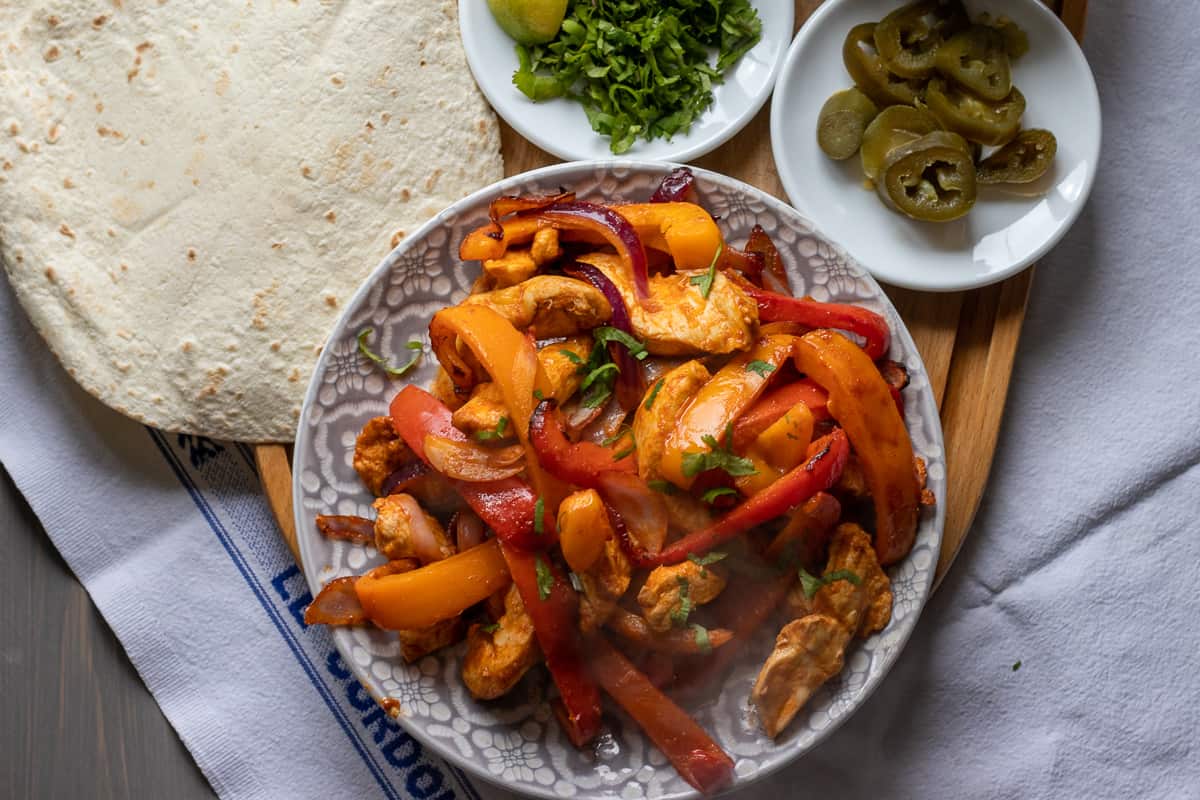 air fryer chicken fajita served with tortilla wraps and jalapeño peppers