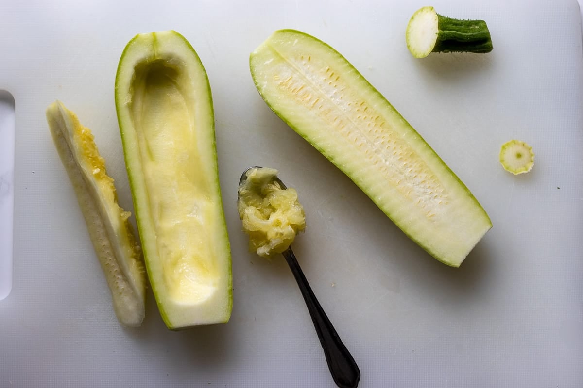 scooping out the inside of zucchini to create a boat shape