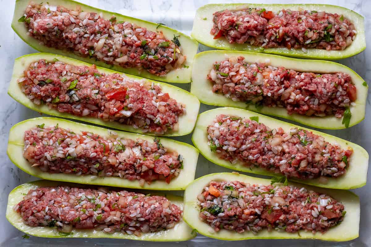 zucchini boats are filled with ground beef and rice filling
