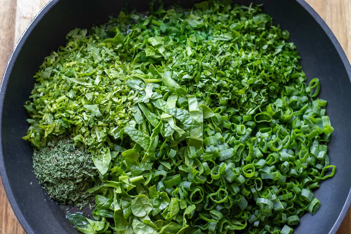 chopped herbs are placed in a pan