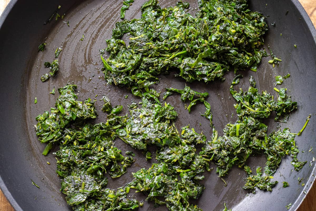 chopped herbs are fried until wilted
