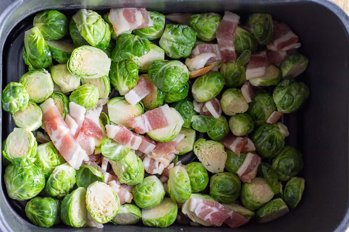 brussel sprouts are placed in the air fryer's basket