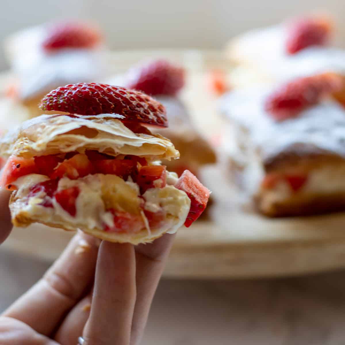 a slice of Easy Strawberry Puff Pastry Stacks with Cream