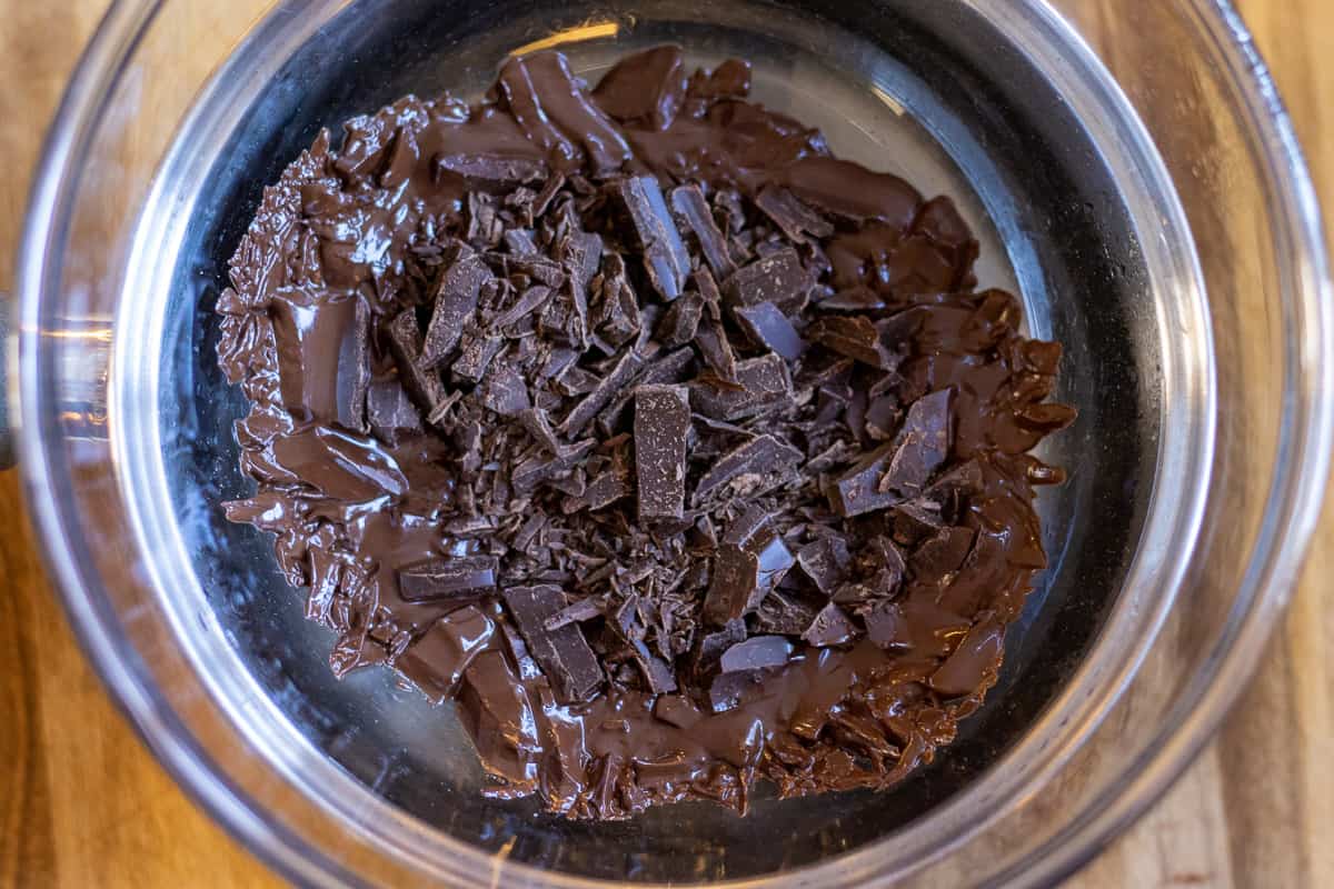 dark chocolate pieces are melting using bain-marie method.