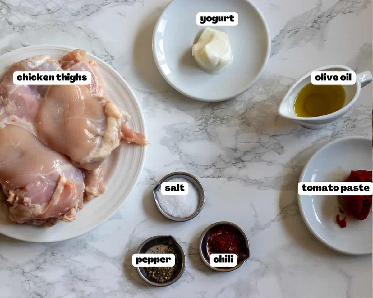 labelled picture of ingredients for baked boneless skinless chicken thighs