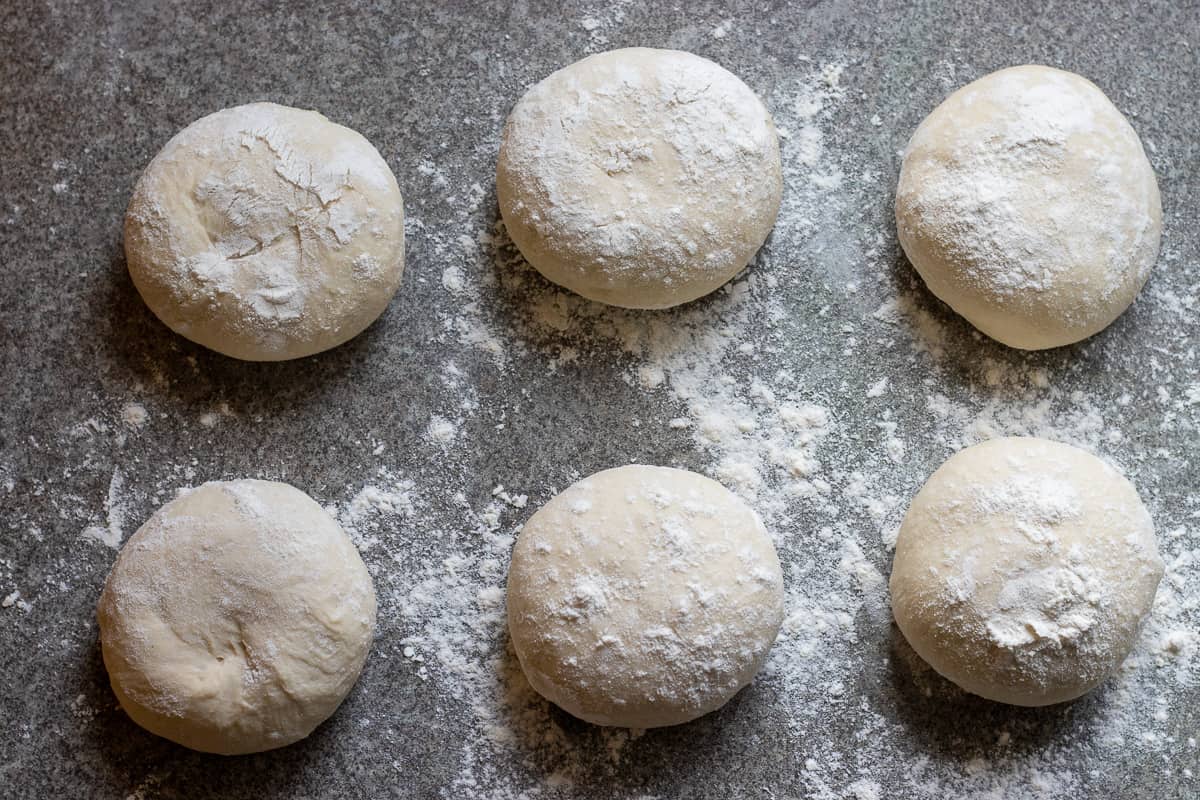 6 equal dough balls are placed on a lightly floured surface