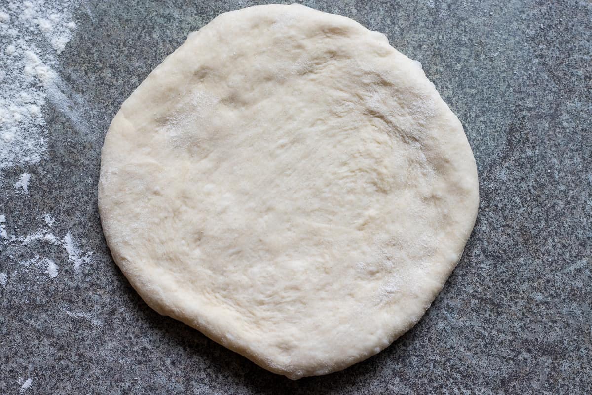a dough ball is rolled into a small circle