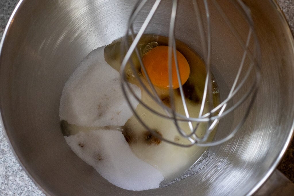 whisking the sugar and eggs in a mixing bowl