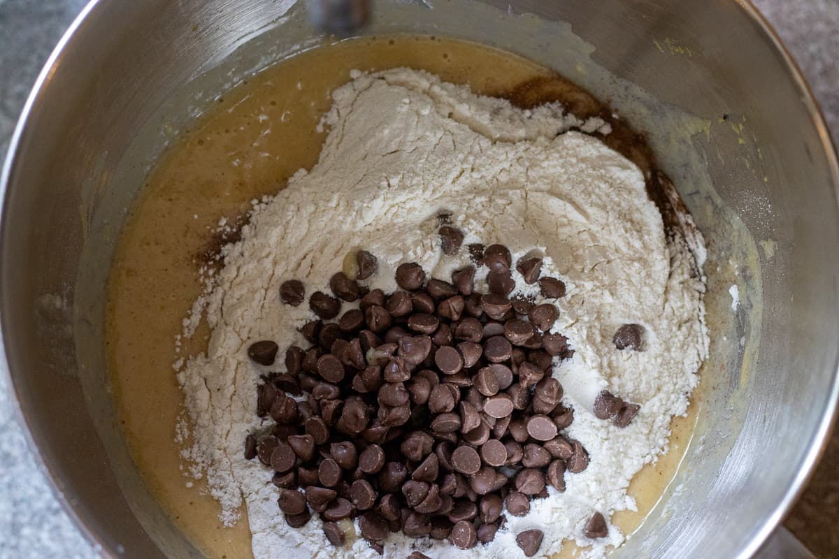 dry ingredients and chocolate chips are added to the bowl with wet ingredients