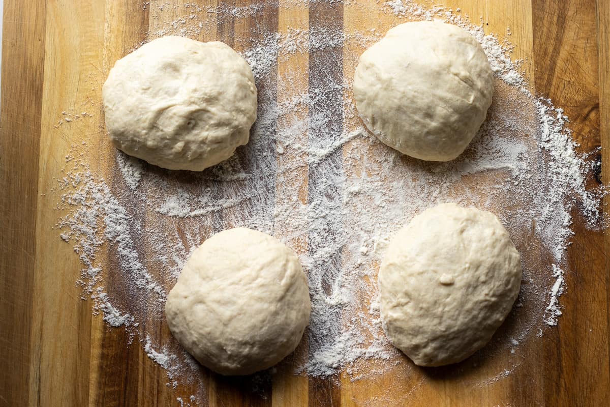 naan dough is divided into 4 balls