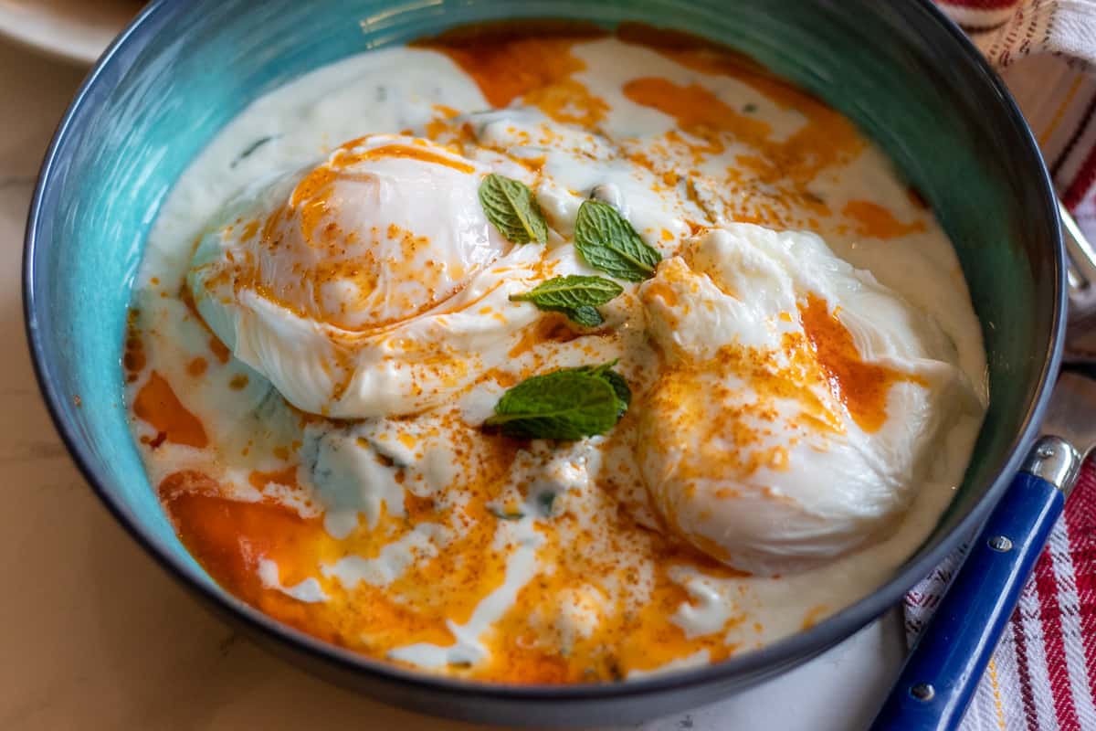 Cilbir turkish poached eggs served with crusty bread