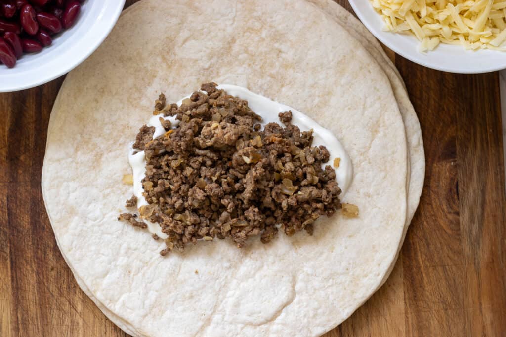 ground beef filling is placed on top of sour cream