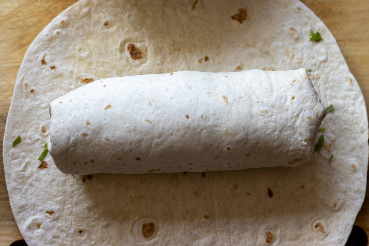 burrito is formed by wrapping the sides of the tortilla wraps