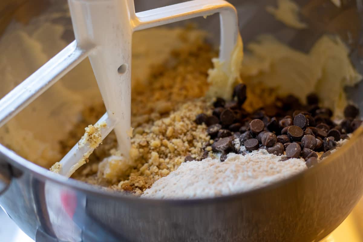 adding the flour, chocolate chips and walnuts into sugar and butter mixture
