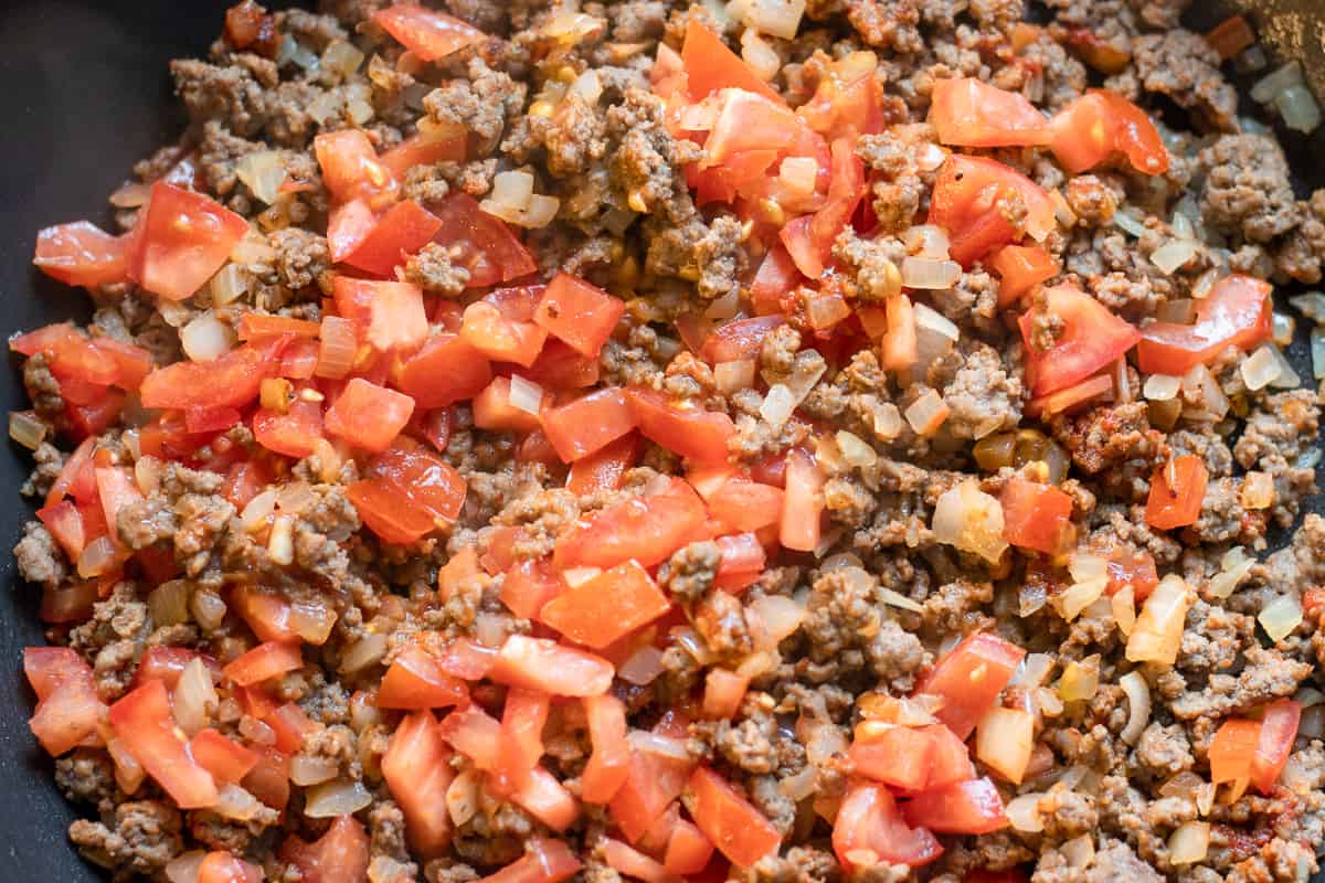 tomatoes are added to mince and onions